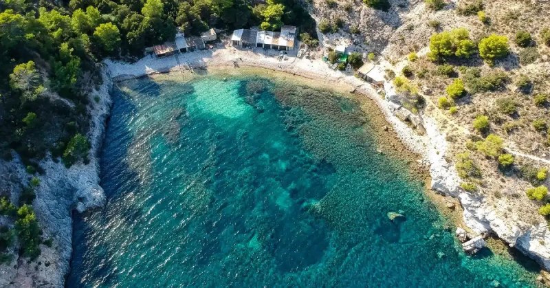 cala lentrisca beach in ibiza, green and blue waters i scenery - Journey Inspirations cala lentrisca beach in ibiza, green and blue waters in scenery