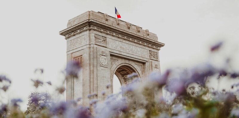 the arch in bucharest romania with the romania flasg