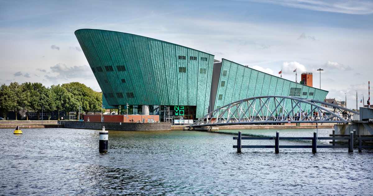nemo museum in amsterdam, a beautiful green building on the sea