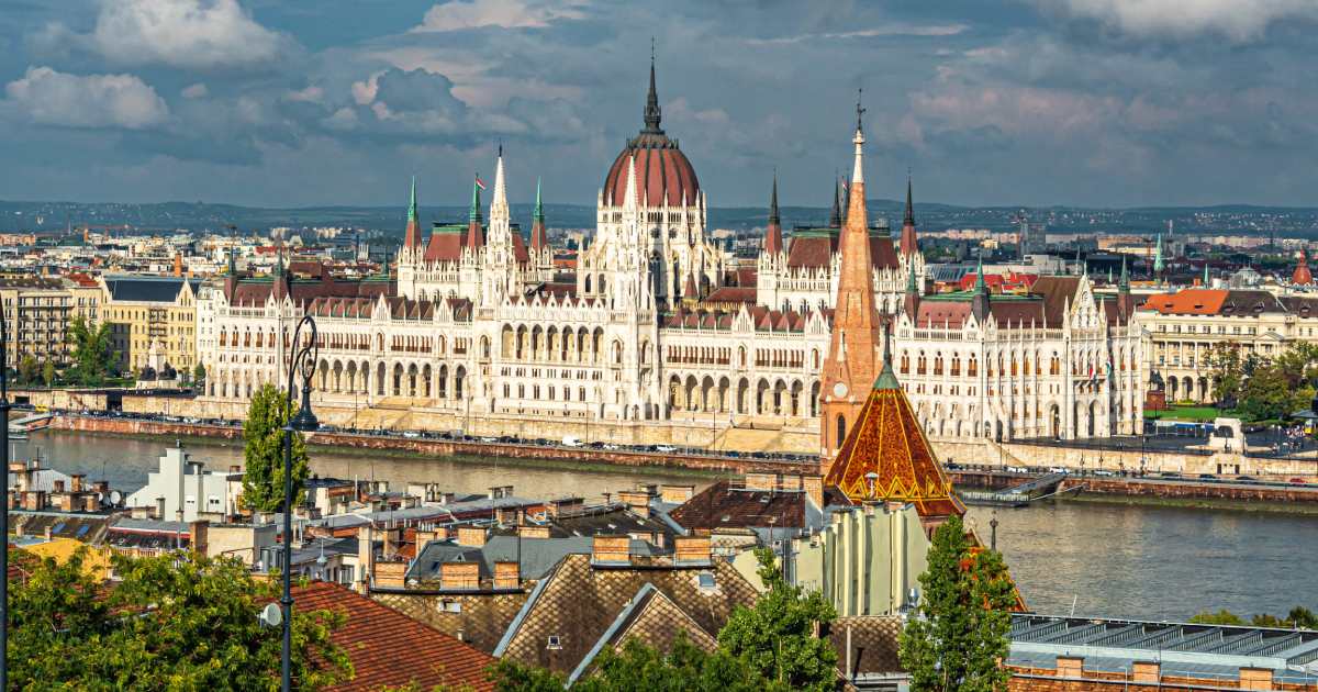 parliament in hungary, large building infront of the sea