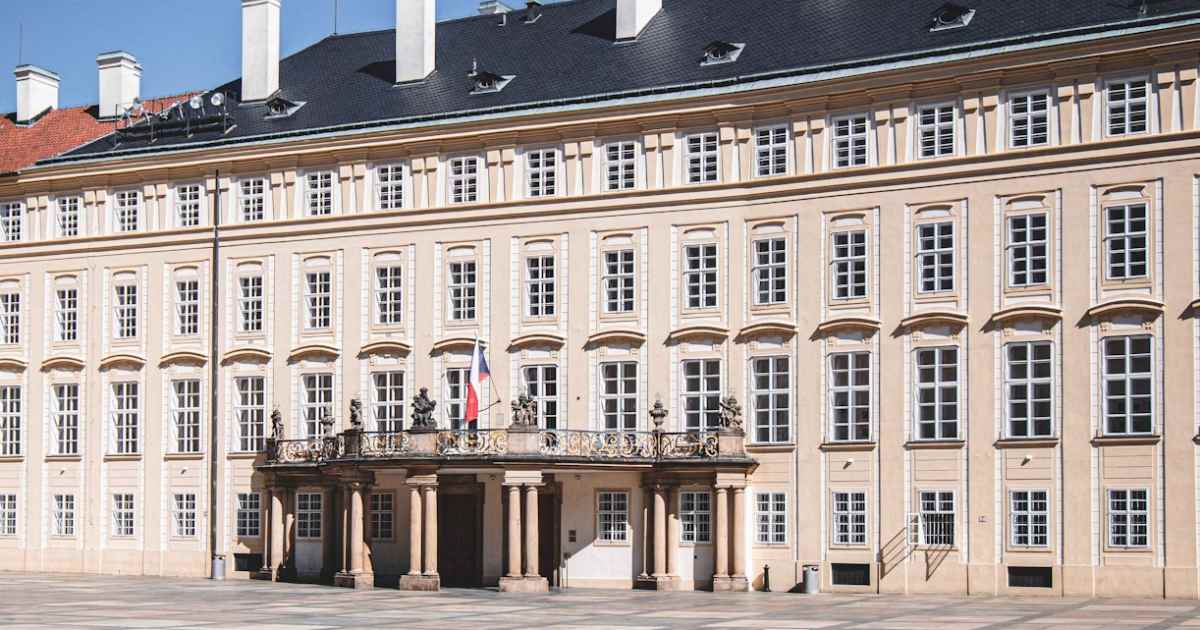 royal palace in prague, high building in white color