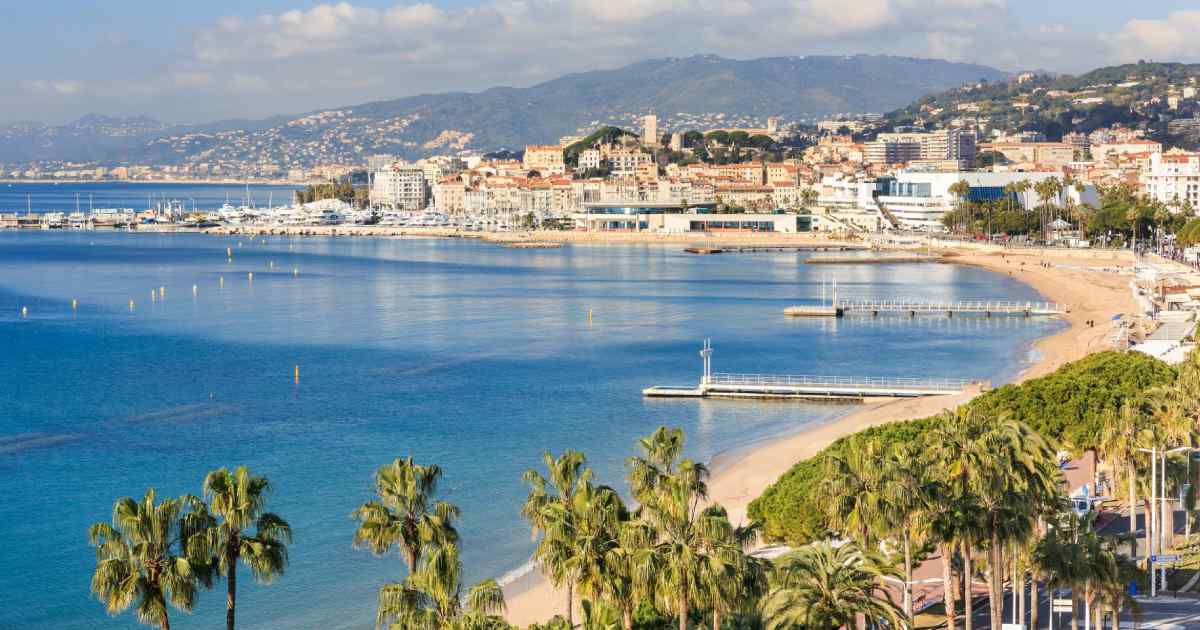 cannes film festival, beach in cannes with houses and trees