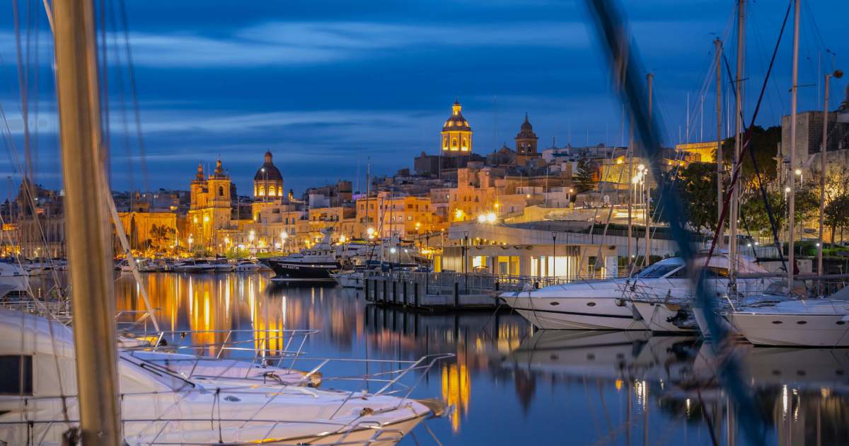 malta by night, boats at the sea and beautiful buildings of malta