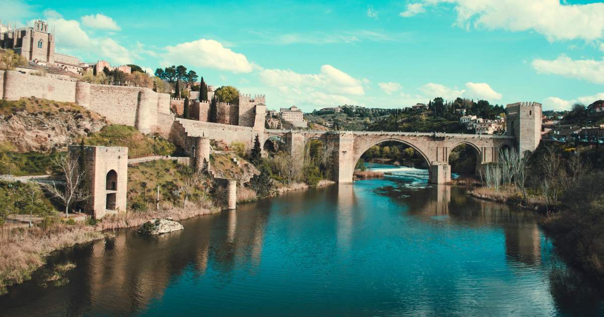 bridge in toledo, with water and trees